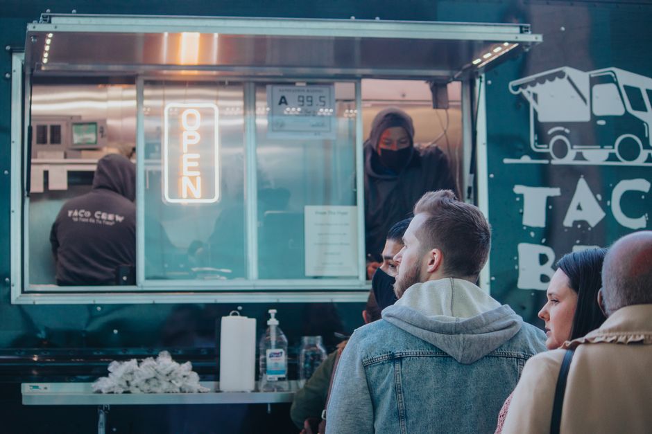 Ordering tacos at the window of the Tacos La Familia truck